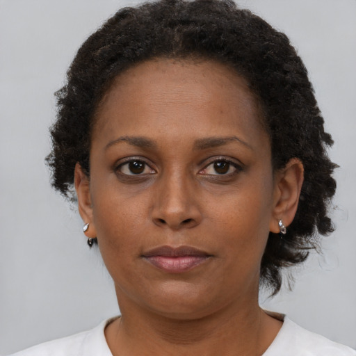 Neutral black adult female with short  brown hair and brown eyes