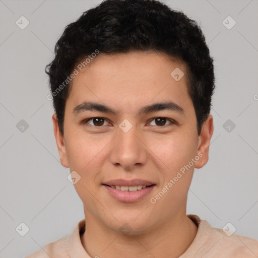 Joyful latino young-adult male with short  brown hair and brown eyes