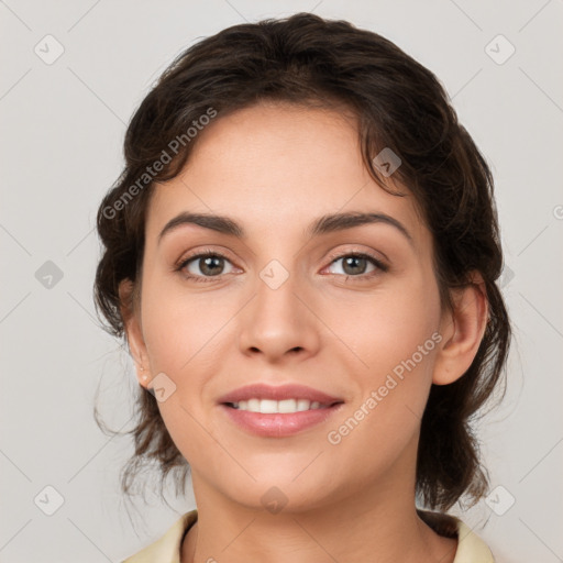 Joyful white young-adult female with medium  brown hair and grey eyes