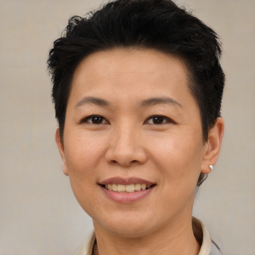 Joyful asian adult female with short  brown hair and brown eyes