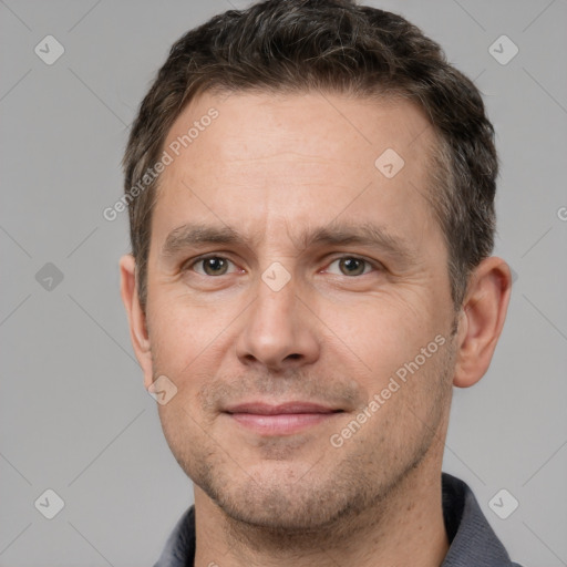 Joyful white adult male with short  brown hair and brown eyes