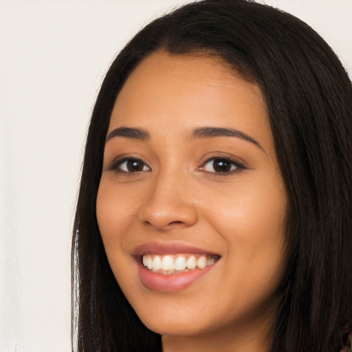 Joyful latino young-adult female with long  black hair and brown eyes