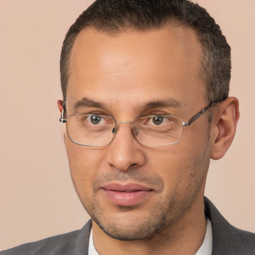 Joyful white adult male with short  brown hair and brown eyes