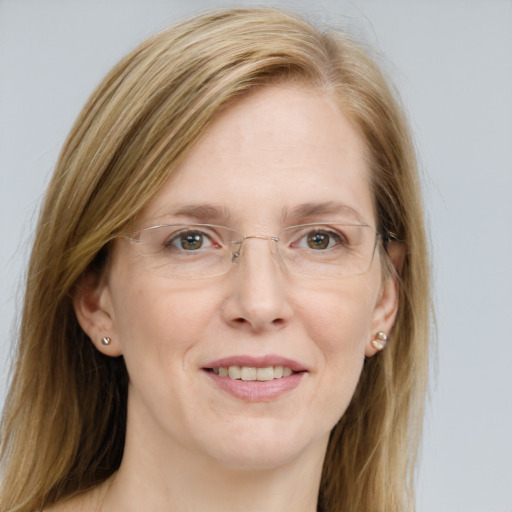 Joyful white adult female with long  brown hair and blue eyes