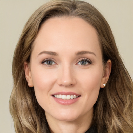 Joyful white young-adult female with long  brown hair and brown eyes