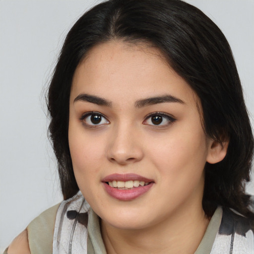Joyful latino young-adult female with medium  brown hair and brown eyes