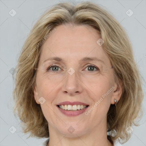 Joyful white adult female with medium  brown hair and blue eyes