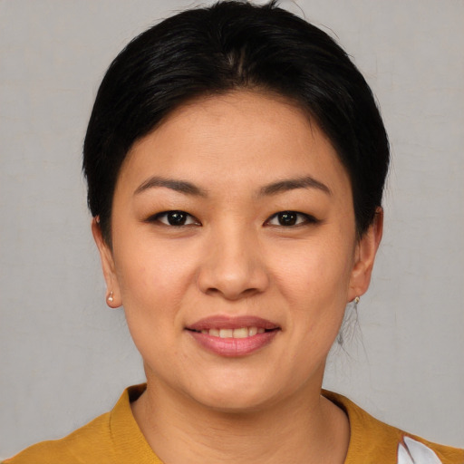Joyful asian young-adult female with short  brown hair and brown eyes