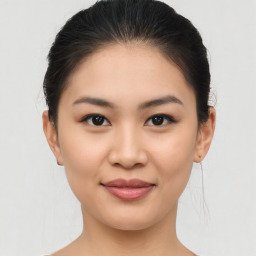 Joyful asian young-adult female with medium  brown hair and brown eyes