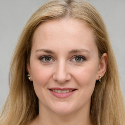 Joyful white young-adult female with long  brown hair and blue eyes