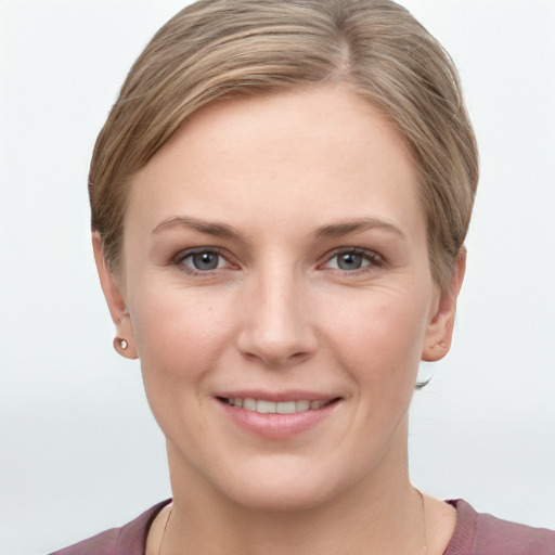 Joyful white young-adult female with short  brown hair and grey eyes