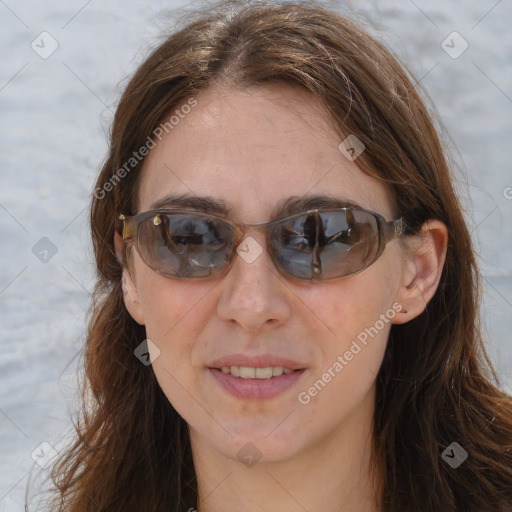 Joyful white adult female with long  brown hair and brown eyes