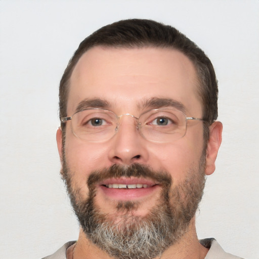 Joyful white adult male with short  black hair and brown eyes