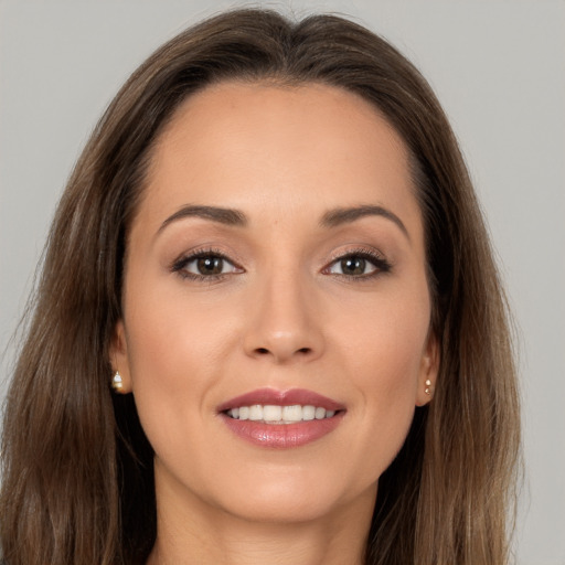 Joyful white young-adult female with long  brown hair and brown eyes