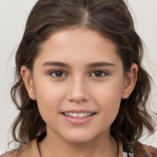 Joyful white child female with long  brown hair and brown eyes