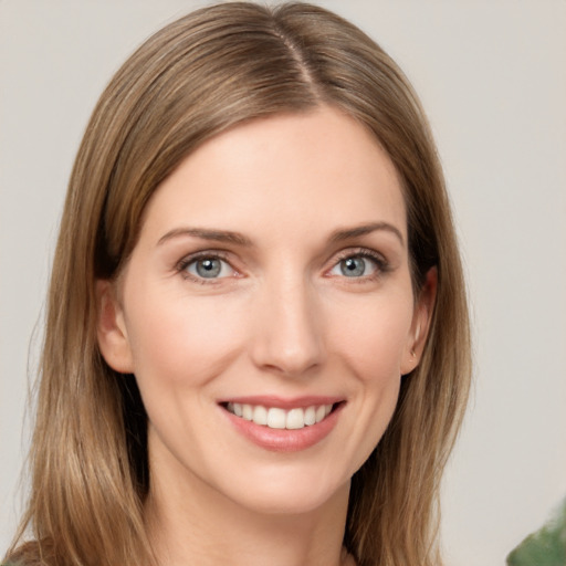 Joyful white young-adult female with medium  brown hair and grey eyes