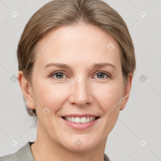 Joyful white adult female with short  brown hair and grey eyes