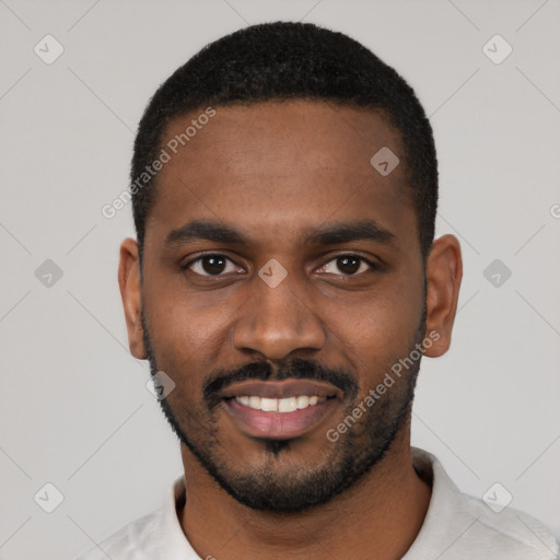 Joyful black young-adult male with short  black hair and brown eyes