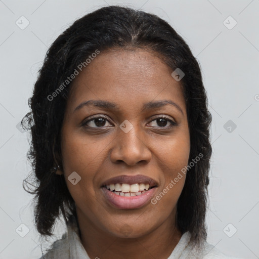 Joyful black young-adult female with long  brown hair and brown eyes