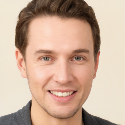 Joyful white young-adult male with short  brown hair and grey eyes