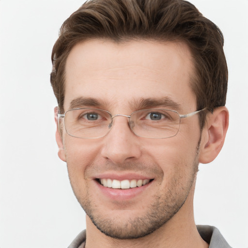 Joyful white young-adult male with short  brown hair and grey eyes