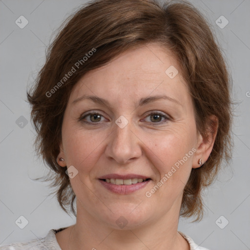 Joyful white adult female with medium  brown hair and blue eyes