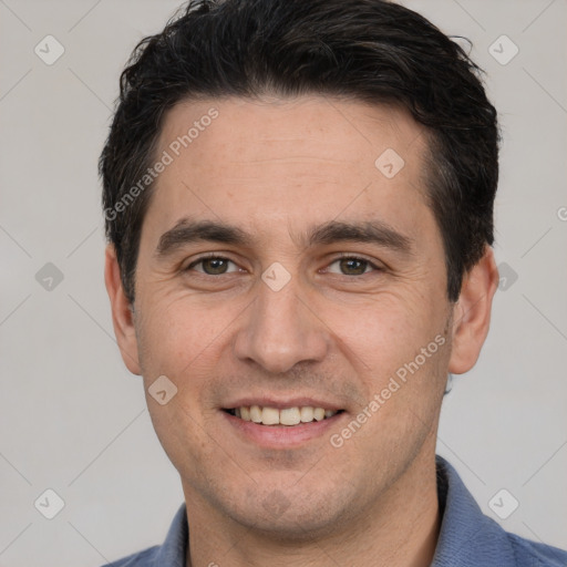 Joyful white young-adult male with short  black hair and brown eyes