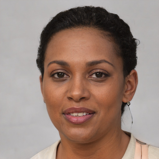 Joyful black young-adult female with short  brown hair and brown eyes