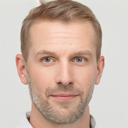 Joyful white adult male with short  brown hair and grey eyes