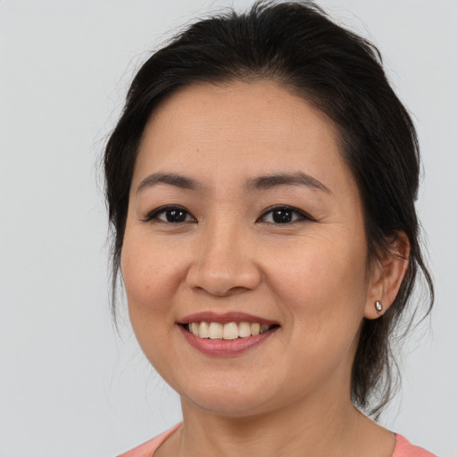 Joyful asian young-adult female with medium  brown hair and brown eyes