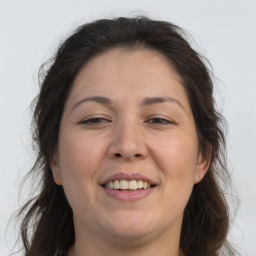 Joyful white adult female with long  brown hair and brown eyes