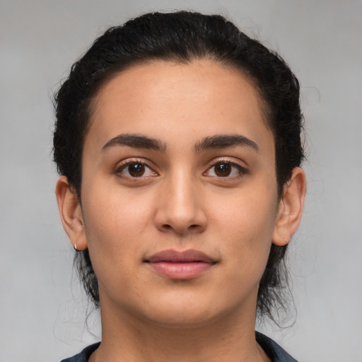 Joyful latino young-adult female with medium  black hair and brown eyes