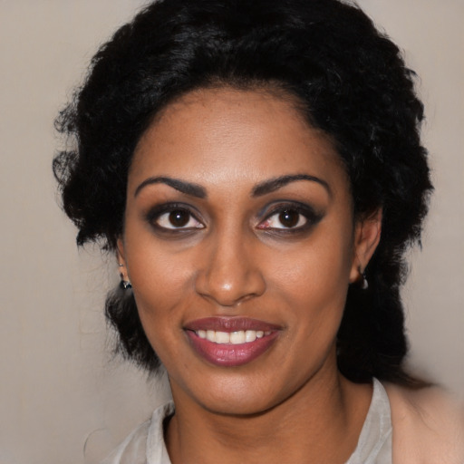Joyful black young-adult female with medium  black hair and brown eyes