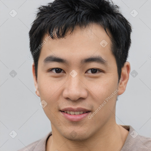 Joyful asian young-adult male with short  black hair and brown eyes