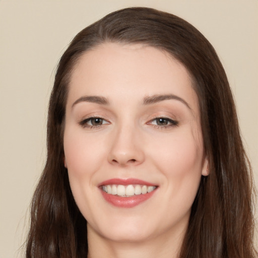 Joyful white young-adult female with long  brown hair and brown eyes