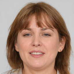 Joyful white adult female with medium  brown hair and brown eyes