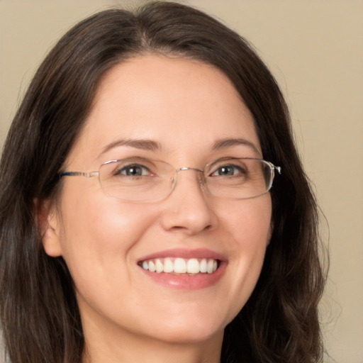 Joyful white adult female with long  brown hair and brown eyes