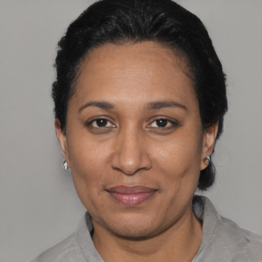Joyful black adult female with short  black hair and brown eyes