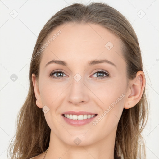 Joyful white young-adult female with long  brown hair and blue eyes