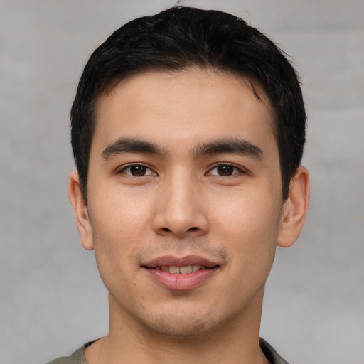 Joyful asian young-adult male with short  black hair and brown eyes