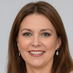 Joyful white adult female with long  brown hair and grey eyes