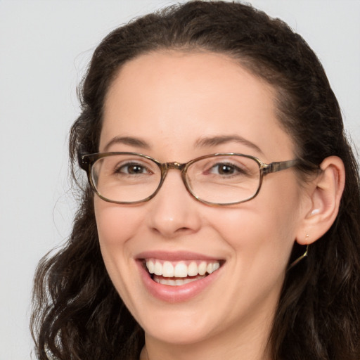 Joyful white adult female with long  brown hair and brown eyes