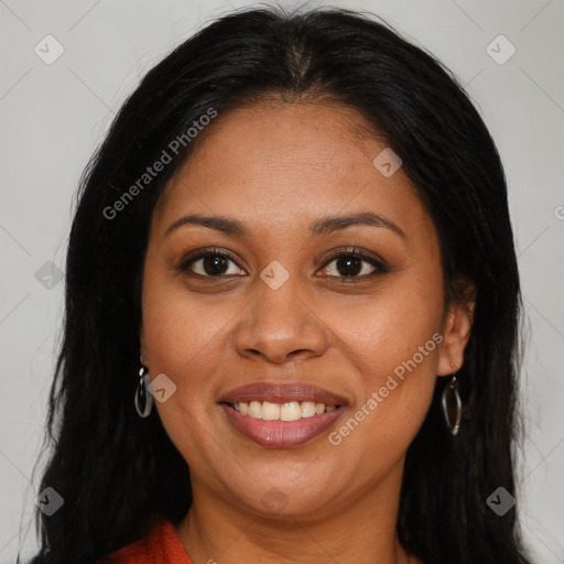 Joyful black young-adult female with long  brown hair and brown eyes