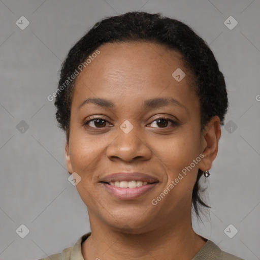 Joyful black young-adult female with short  black hair and brown eyes