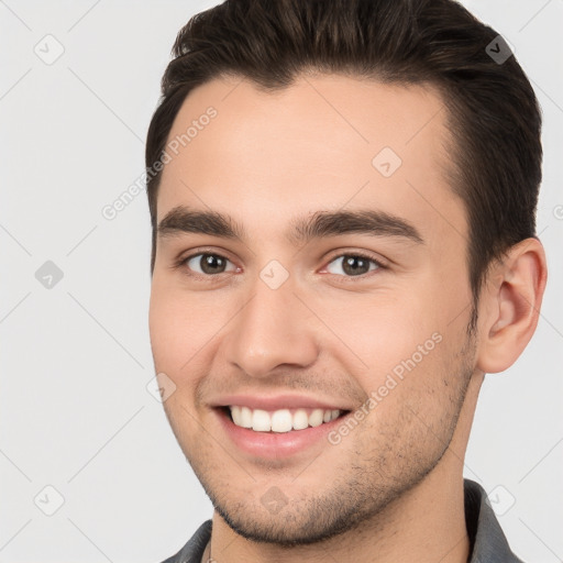 Joyful white young-adult male with short  brown hair and brown eyes