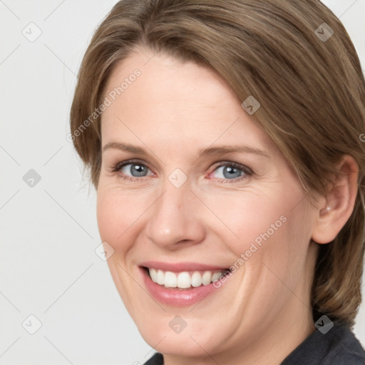 Joyful white adult female with medium  brown hair and grey eyes