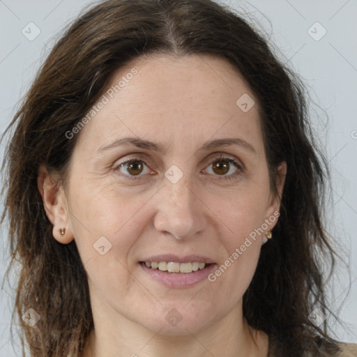 Joyful white adult female with long  brown hair and brown eyes