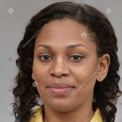 Joyful black adult female with medium  brown hair and brown eyes