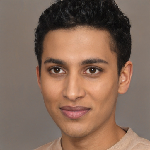 Joyful latino young-adult male with short  black hair and brown eyes