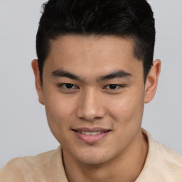 Joyful asian young-adult male with short  brown hair and brown eyes